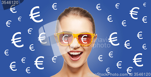 Image of happy woman in shades with euro currency sings