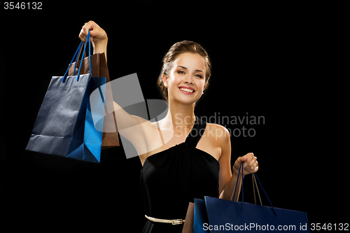Image of smiling woman in dress with shopping bags