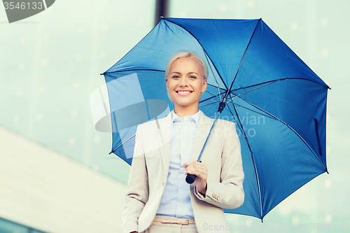 Image of young smiling businesswoman with umbrella outdoors