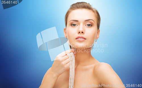 Image of beautiful woman with pearl earrings and bracelet