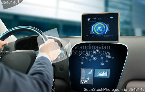 Image of close up of man with tablet pc driving car