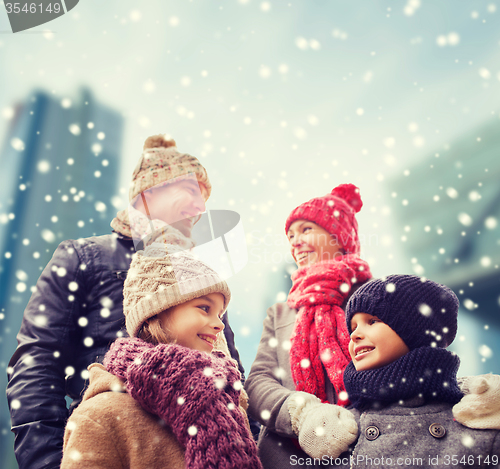 Image of happy family in winter clothes outdoors