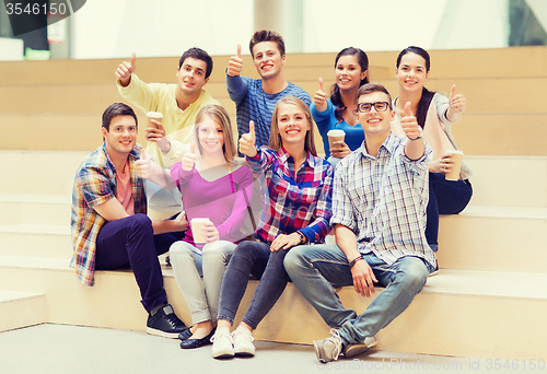 Image of group of smiling students with paper coffee cups