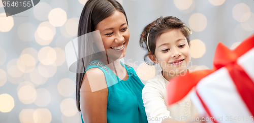 Image of happy mother and child with gift box