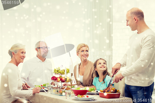 Image of smiling family having holiday dinner at home