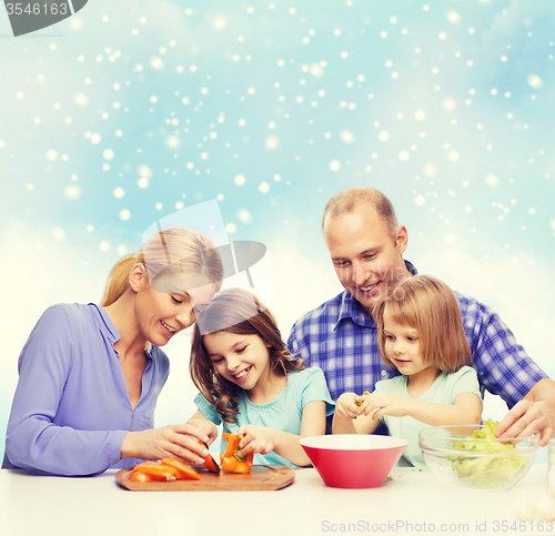 Image of happy family with two kids making dinner at home