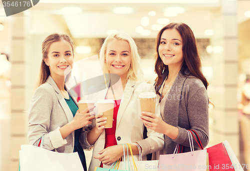 Image of young women with shopping bags and coffee in mall