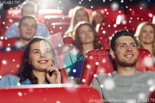 Image of happy friends watching movie in theater