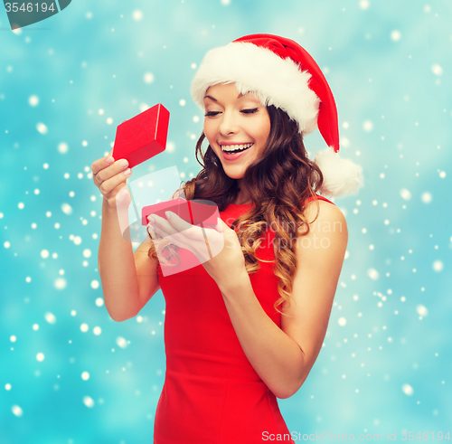 Image of smiling woman in santa helper hat with gift box