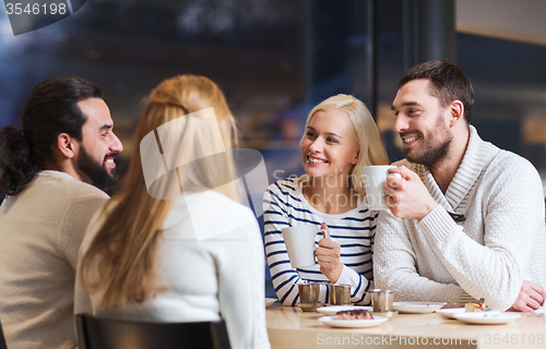 Image of happy friends meeting and drinking tea or coffee