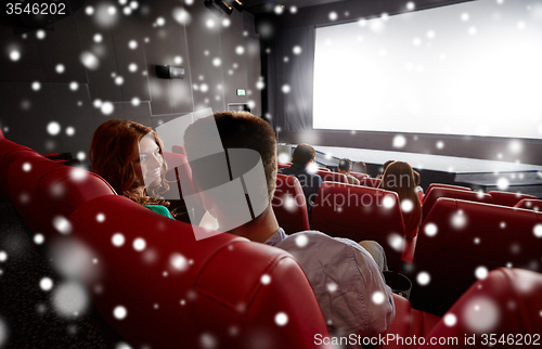 Image of happy friends or couple watching movie in theater