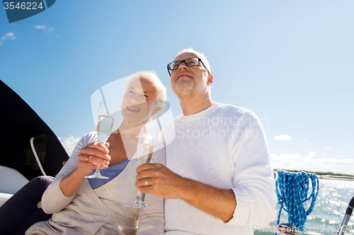 Image of senior couple with glasses on sail boat or yacht