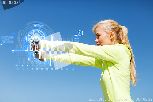 Image of sporty woman with light dumbbells outdoors