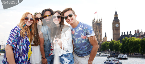 Image of happy hippie friends with selfie stick at coliseum