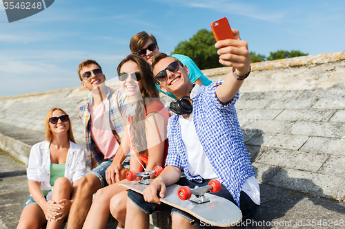 Image of happy friends with smartphone taking selfie