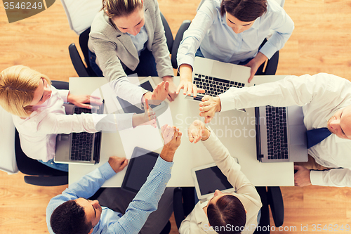 Image of close up of business team showing high five