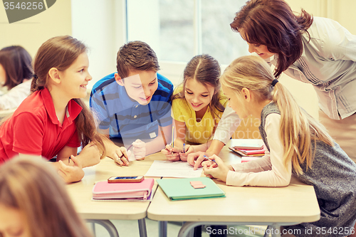 Image of group of school kids writing test in classroom