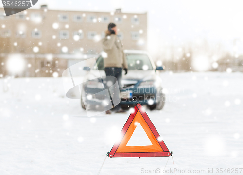 Image of closeup of man with broken car and smartphone