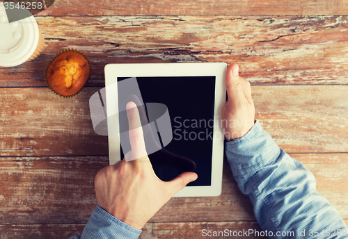 Image of close up of male hands with tablet pc and coffee