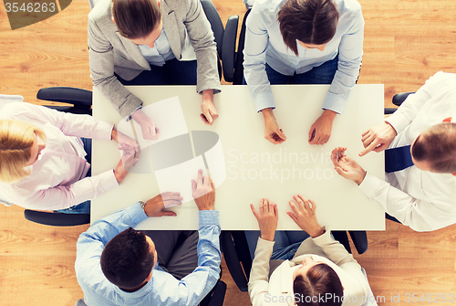 Image of close up of business team sitting at table