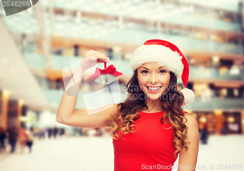 Image of smiling woman in santa helper hat and jingle bells