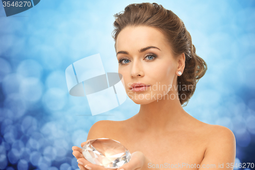 Image of woman showing big diamond over blue lights