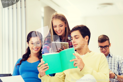 Image of group of smiling students with tablet pc