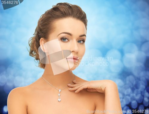 Image of woman wearing shiny diamond pendant