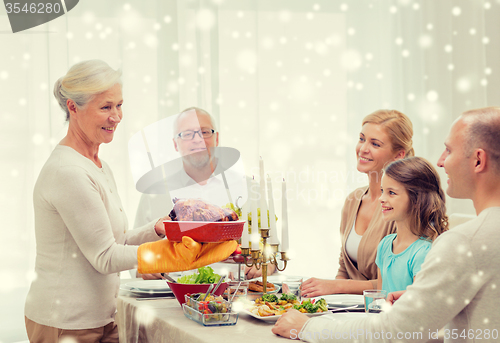 Image of smiling family having holiday dinner at home