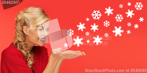 Image of woman sending snowflakes from palms of her hands