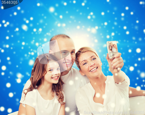 Image of happy family with camera at home