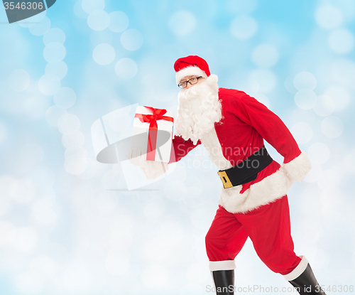 Image of man in costume of santa claus with gift box