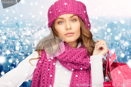 Image of young woman in winter clothes with shopping bags