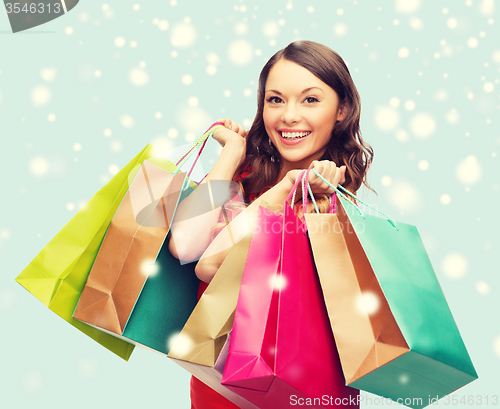 Image of woman in red dress with shopping bags