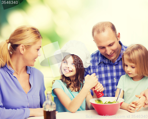 Image of happy family with two kids eating at home