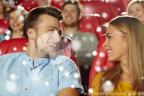 Image of happy friends or couple watching movie in theater