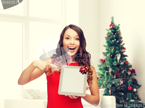 Image of smiling woman in red dress with tablet pc
