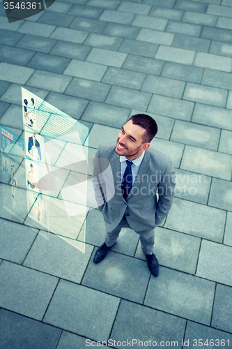 Image of young smiling businessman outdoors from top