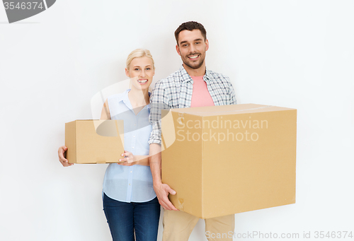 Image of couple with cardboard boxes moving to new home