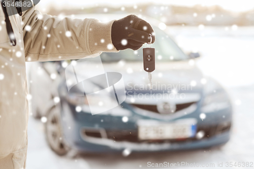 Image of close up of man with car key outdoors