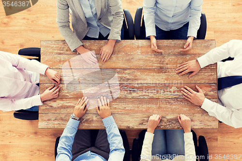 Image of close up of business team sitting at table