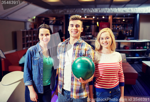 Image of happy friends in bowling club