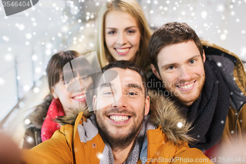 Image of happy friends taking selfie on skating rink