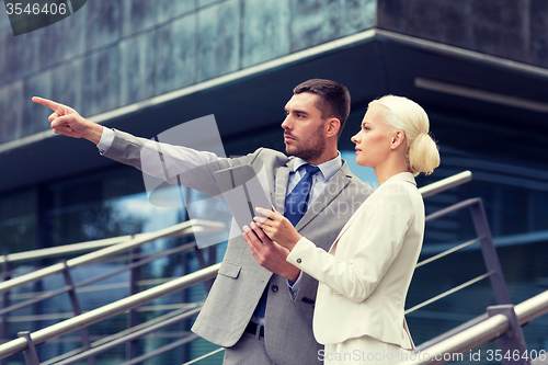 Image of serious businessmen with tablet pc outdoors