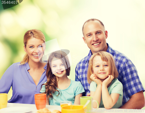 Image of happy family with two kids with having breakfast