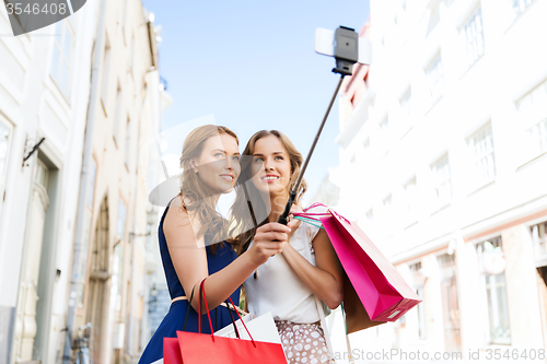 Image of women shopping and taking selfie by smartphone