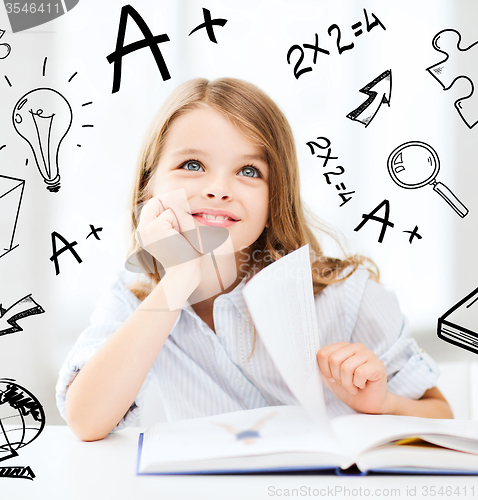 Image of little student girl studying at school