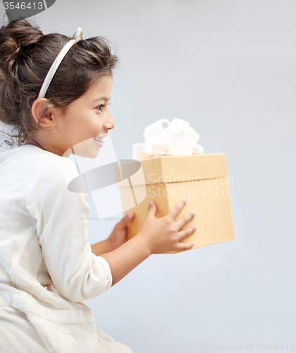 Image of happy little girl with gift box at home