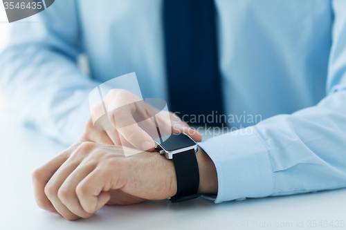 Image of close up of male hands setting smart watch