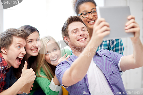 Image of group of happy high school students with tablet pc